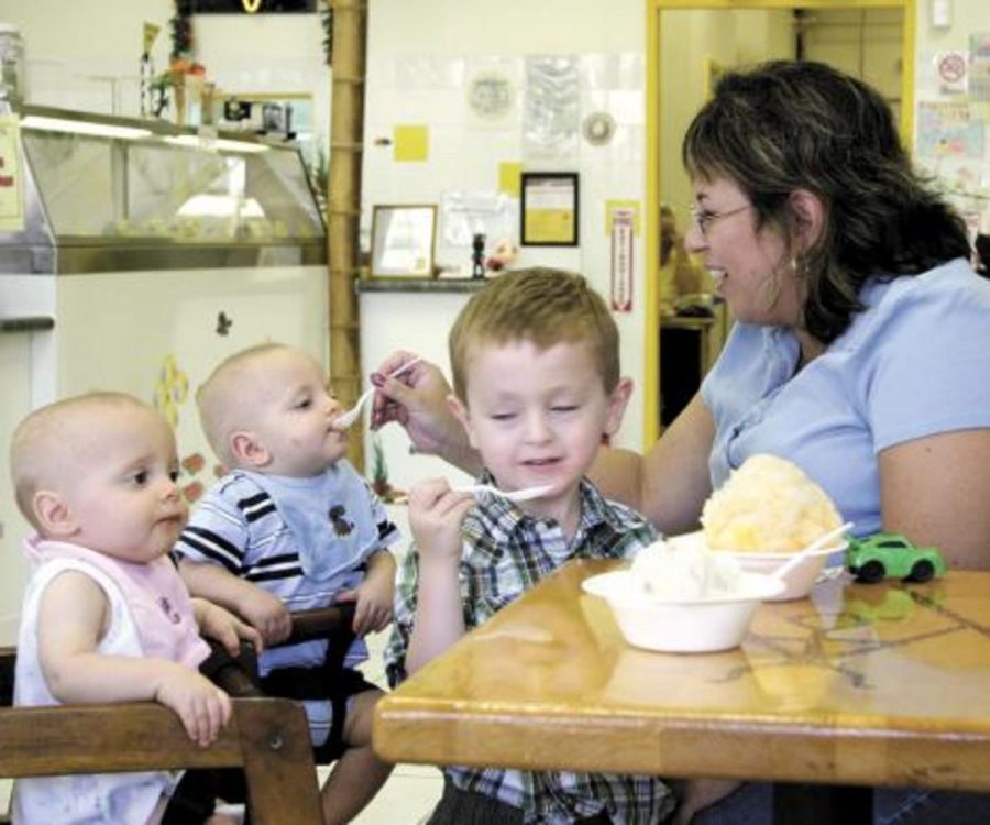 Nine-month-old twins Hayden and Alex Kelly, left, enjoy scoops of banana shaved ice with family friends Veronica Kelly, right, and her son Chaz at TutuÂ´s Hawaiian Ice Cream Shack in Simi Valley.