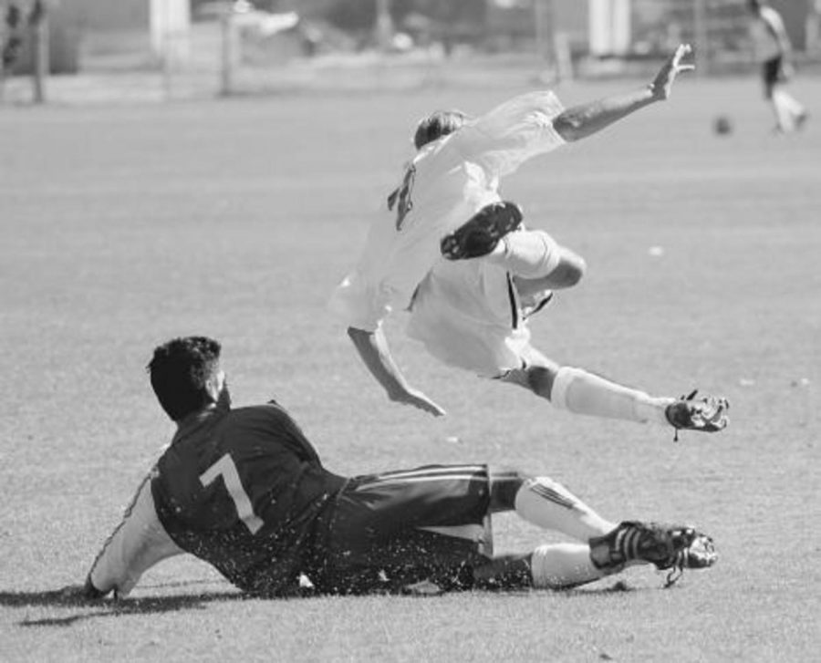 Ruben Reyes, left, slide tackles Carson Chappell, right, trying to get possesion of the ball in the deadlocked game.  Both teams played an aggressive style of defense keeping each other out of the nets.