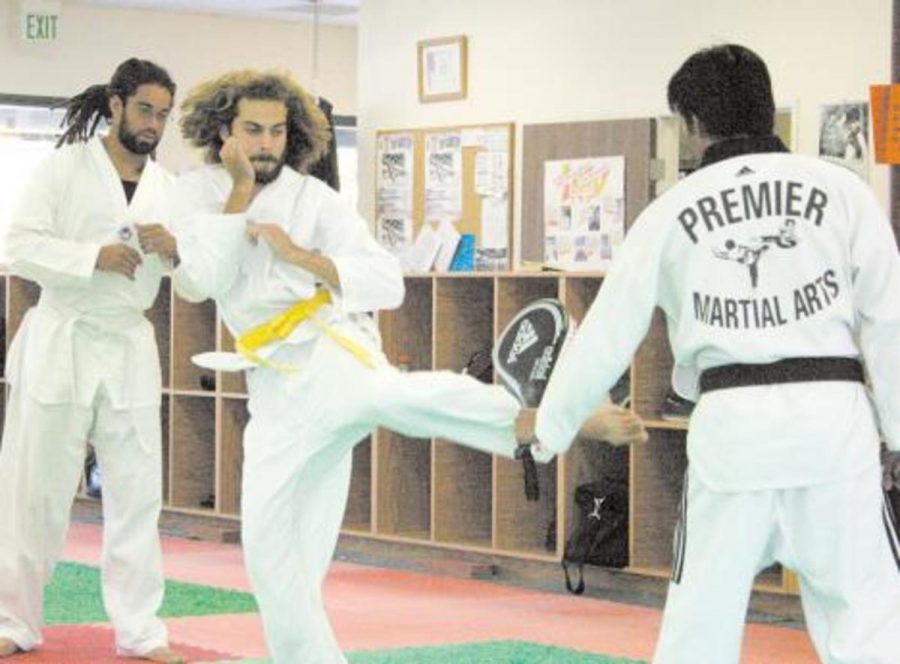 Michael Wilson, middle, practices his kicks for the upcoming martial arts competition that will be held at Ventura College.