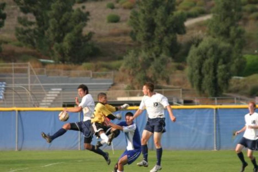 MoorparkÂ´s Joe Gutierrez, left, got past Oxnard goalie Kenny Negron, left center,  but failed to score in the 1-0 Oxnard victory earlier this season.  Oxnard showed huge improvement this season and will be a team to look for next season.  Both Moorpark and Oxnard missed the playoffs this season.