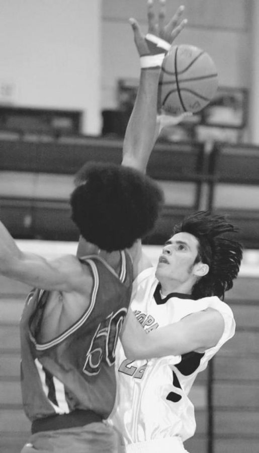 MoorparkÂ´s Ivan Barragan, right, runs into trouble as West Hills forward Albert Moore goes for the block.  MoorparkÂ´s offense is playing well so far this season.  The Raiders put up 114 points in a win against Barstow.