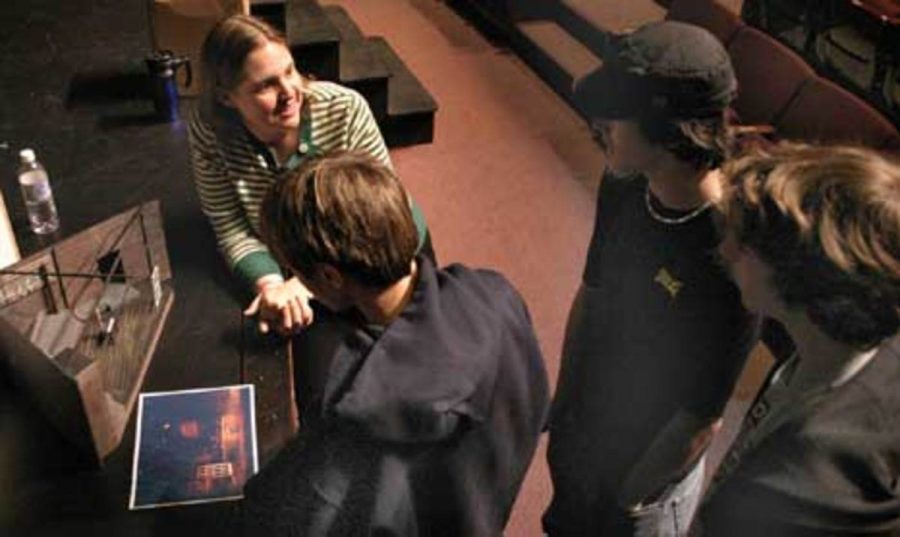 Christina M. Burck, production manager of the Rubicon Theatre Company, shows visiting students a scale model of a set for a play.