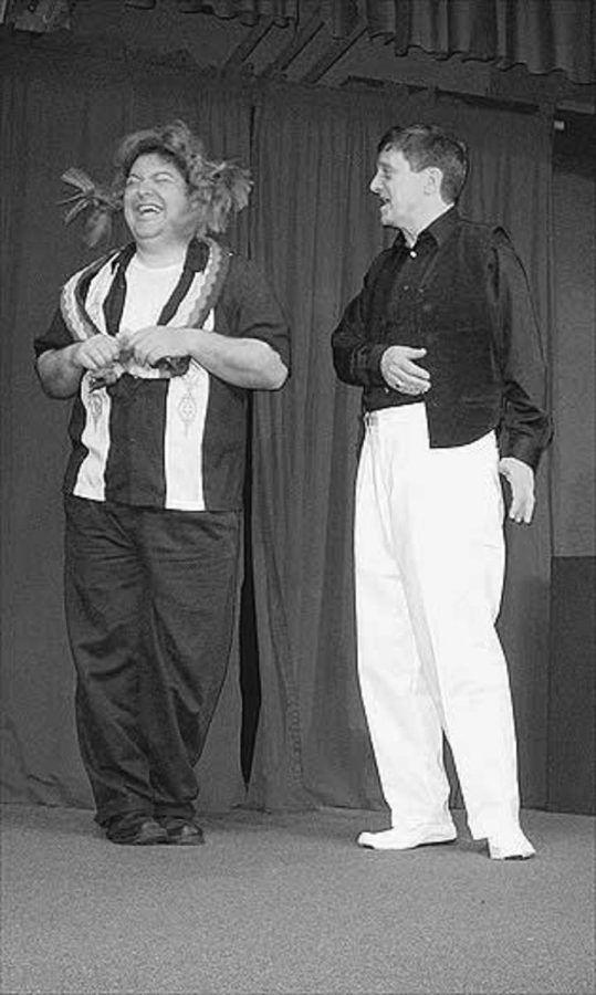 Tom Mueller, left, with John Medeiros performs a scene in which Tom is flirting with John who is a cross dresser trying to file taxes as a girlfriend.