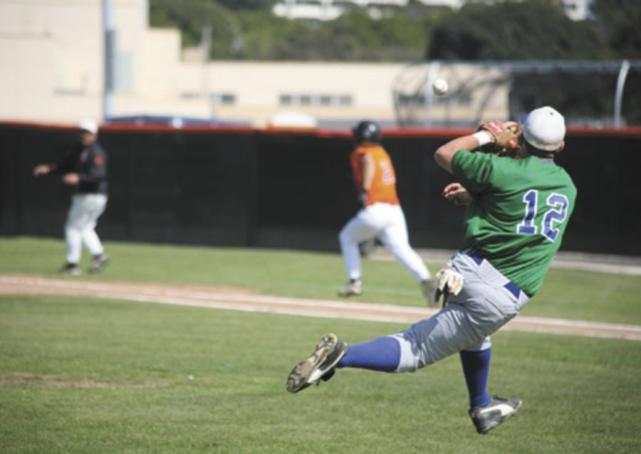 Ventura College's Jason Nash (12) retrieves a bunt hit by Oxnard College's Mike Ziemke in the bottom of the fourth inning. Oxnard College went on to win 4-0 in a game played on April 27.