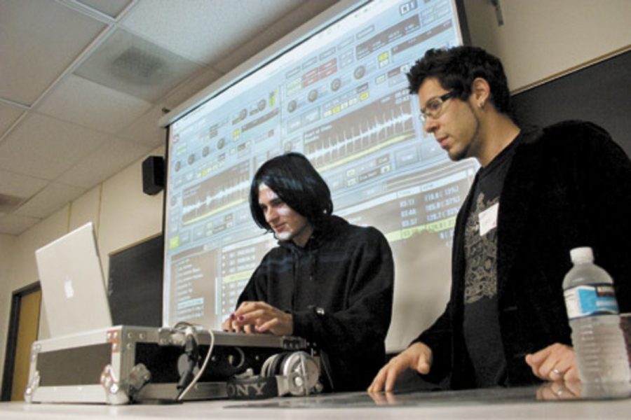 DJ Eric Jerome, right, explains to Robert Davis, 23, a psychology major at CSUCI, how to use the digital mixing software program "Tracktor." The Moorpark College Multimedia Club's first annual festival took place on April 29 and introduced a myriad of forms of media.