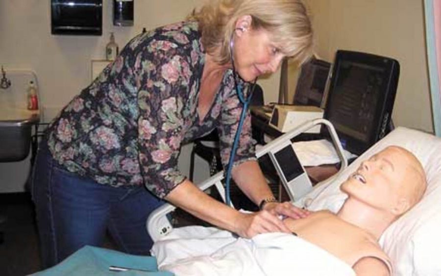 Second semester nursing major Victorian Banks works with SimMan, a new mannequin purchased by the MC nursing program.