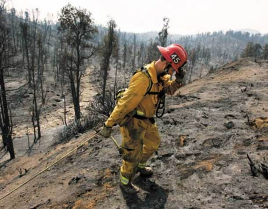Ventura County Fire Captain, Phil Hadley, adjusts his cap as he prepares to help his fellow firefighters put out hot spots in Los Padres National Forest near Lockwood Valley, Calif., Thursday, Sept. 28, 2006. 