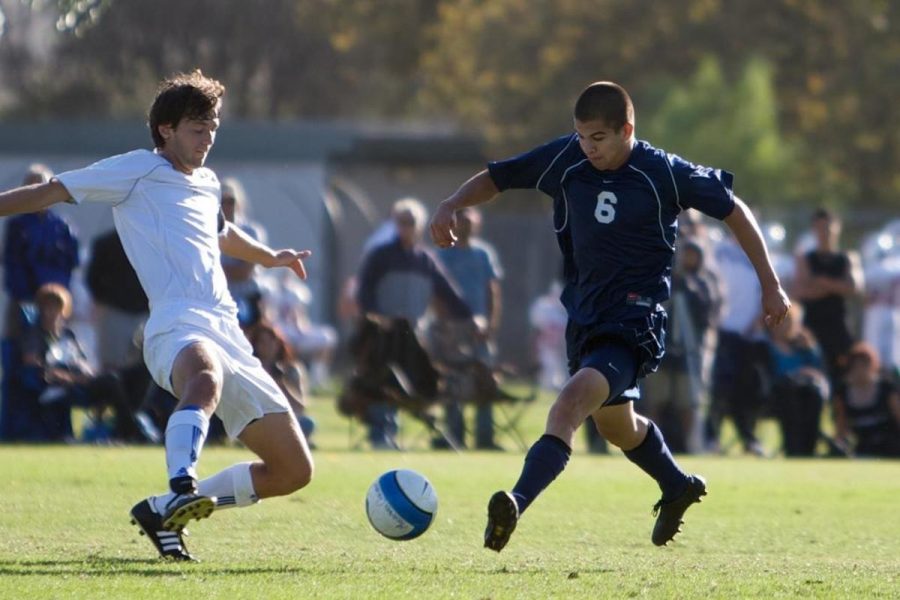 An unidentified Oxnard College player challenges Adrian Llamas, right, of Moorpark College. 