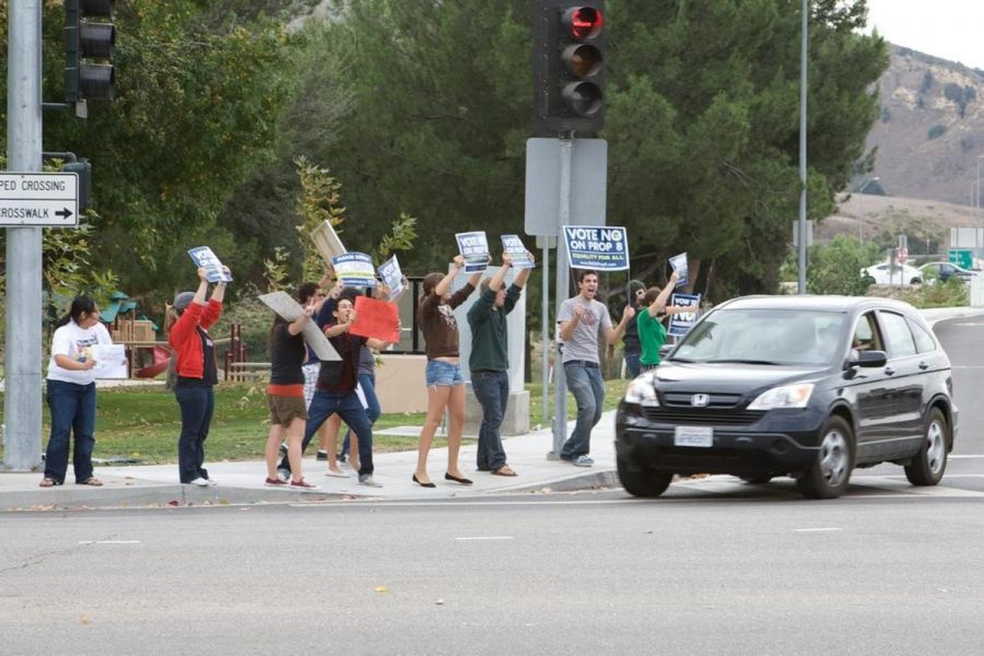 Students protest against propostion 8 at the corner of Collins and Campus Dr. the Thursday before the election.