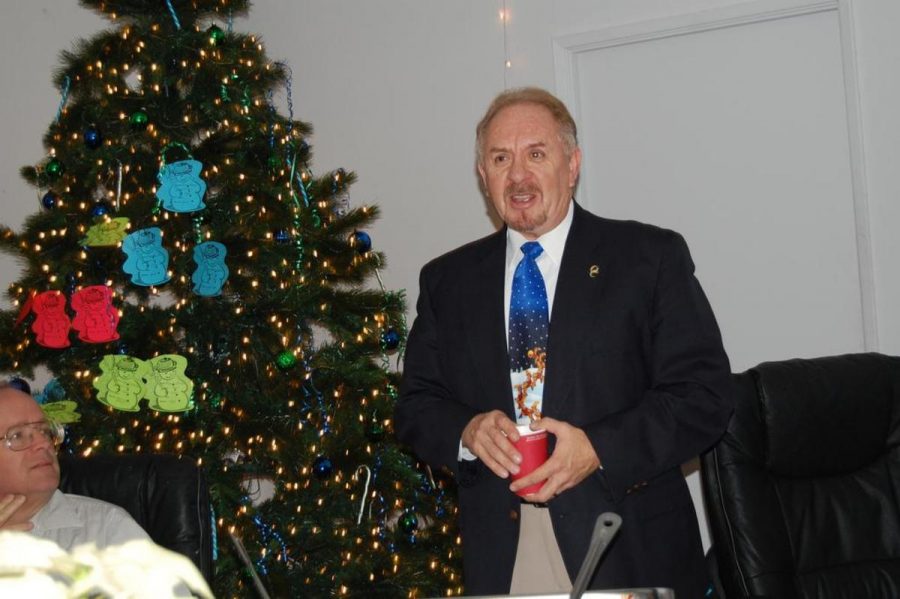 Dr. Richard Duran, Oxnard College president, stands by the Oxnard College Giving Tree.