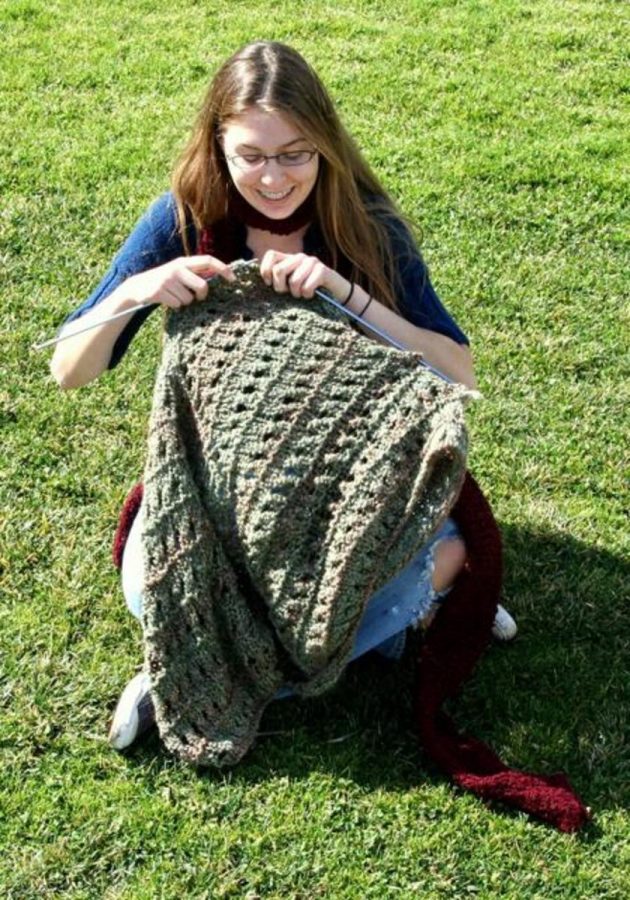 Sierra Cook, 16, the founder and president of the Knitwits, knits in the grass. Hers is the first knitting club in Moorpark Colleges history.