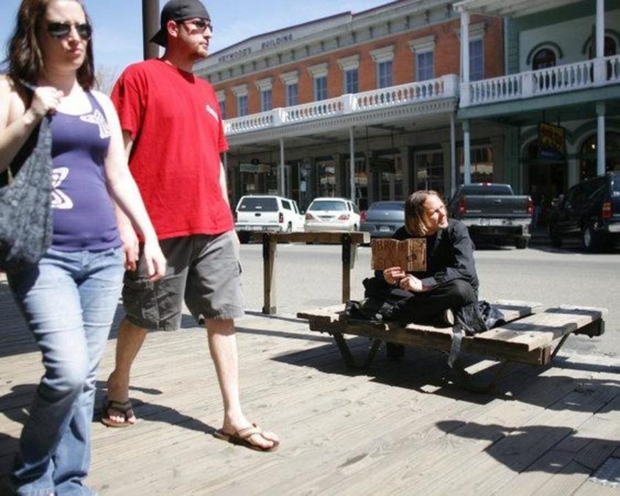 Two+tourists+walk+by+John+Jones%2C+27%2C+right+and+his+kissing+booth+along+Second+St.+in+Old+Sacramento.+Jones+said+he+panhandles+along+Second+St.+regularly+and+makes+enough+money+from+passing+tourists+to+buy+food.