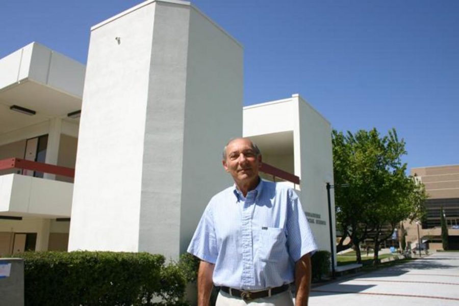 Former philosophy Professor Paul Fink stands outside of the Humanities and Social Sciences building where he taught for 22 years.