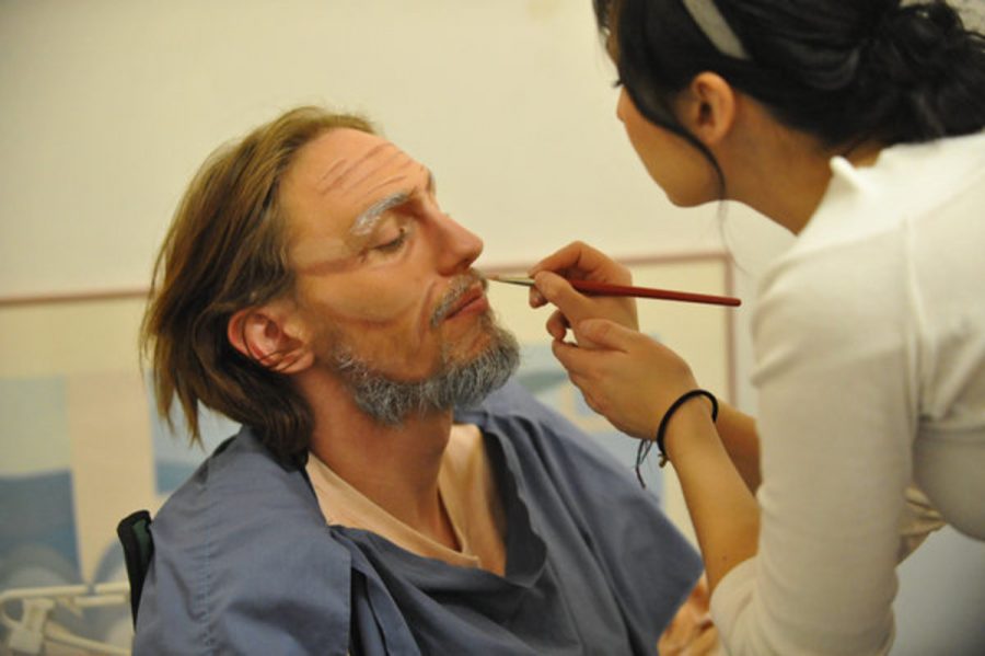 Hair and Makeup artist Claudia applies some of the detail to Sean "Murph" Murphy's face to age him by a few decades.