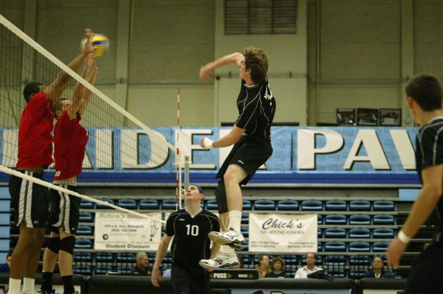 Moorparks middle blocker No. 18 Sean Martin goes up for the kill as setter No. 10 Adam Quinn looks on.