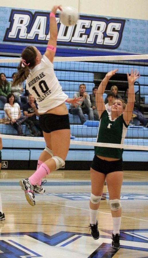 Moorparks Rachel Olinyk spikes a ball while a Cuesta defender attempts to block it in a Western State Conference match-up on Friday night. The Raiders won the match in three sets.