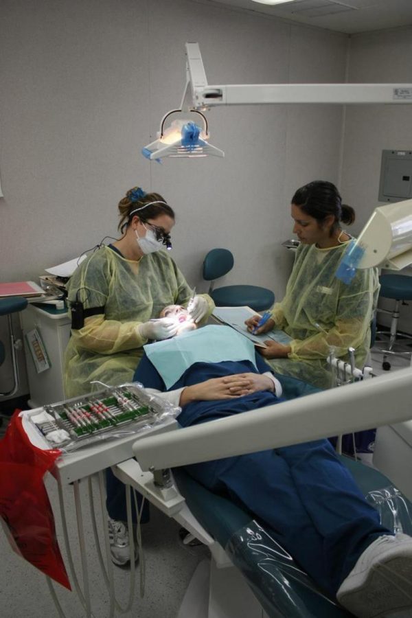 From left to right, Stacie Lee 27, Amina Lawson 31, Jessica Ramirez 29, dental hygene majors, get hands on experience by working on each other.