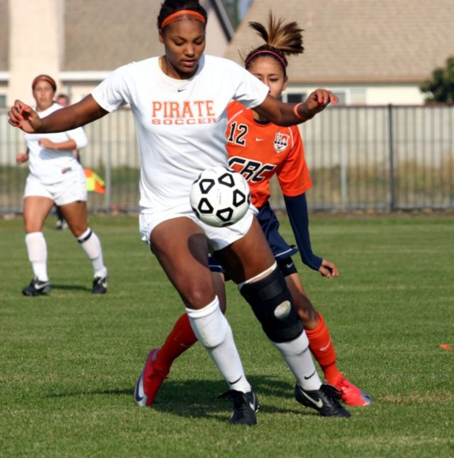 Pirates midfielder Jazmarae Strozier, front, attempts to control a ball, while the Hawks Rebeca Galo defends.