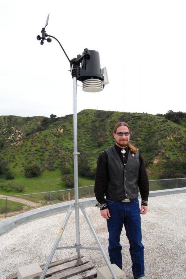 Michael Walegur stands beside his newly-installed weather equipment.