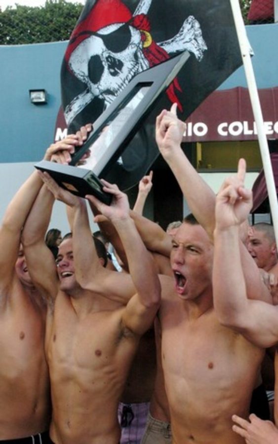 Members of the Ventura College swimming and diving team hold up the state championship trophy after beating out Orange Coast College for the title at the state championships on May 1.