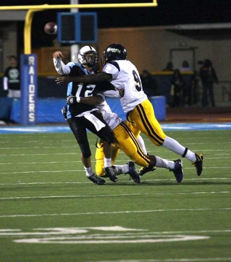 Quarterback; Ian Shultis scrambles to get the ball away before getting tackled, October 10th, 2009