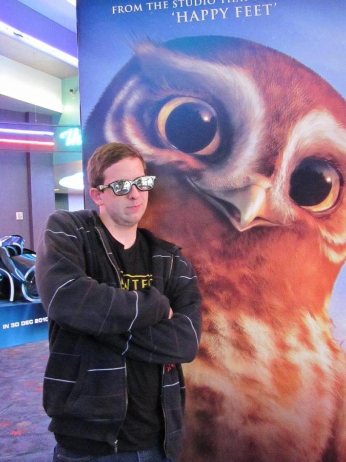 Four eyes - Peter Strand, 18, film major poses with the new Legend of the Guardians poster.