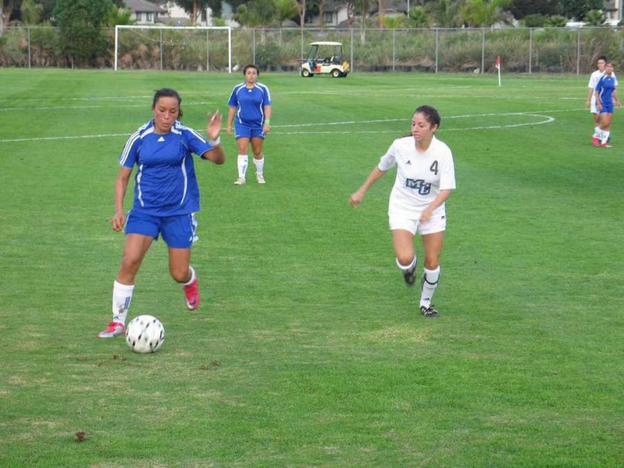 Oxnard defender Alicia Valdez fights off Moorpark mid-fielder Amanda Viescas