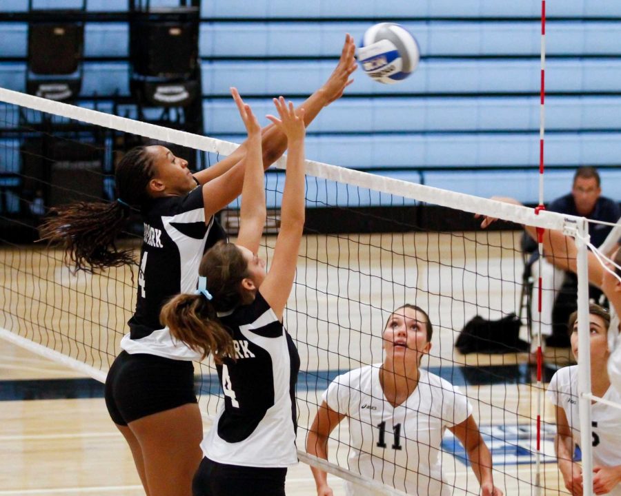 Karissa Flack (l) and Jessica Soprano go up for a block as Irvine Valley players look on at Raider Pavilion on Sept. 23, 2011. The Raiders won the match in four games. Photo by Jeffrey Farrar.