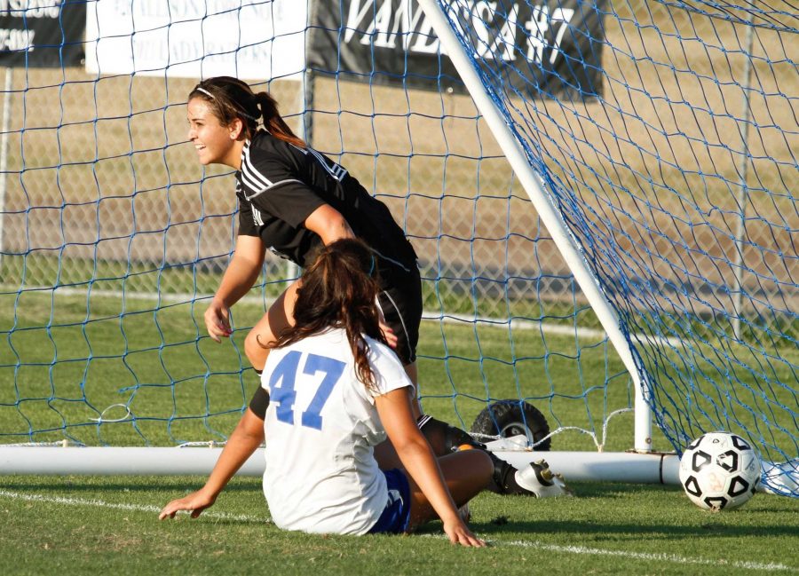 Raider Marylin Alvarez crawls out of the goal after scoring in the 84th minute against Corsair Gabby Rodriguez at Raider Field on Sept. 23, 2011. The Raiders and Corsairs tied, 1-1. 