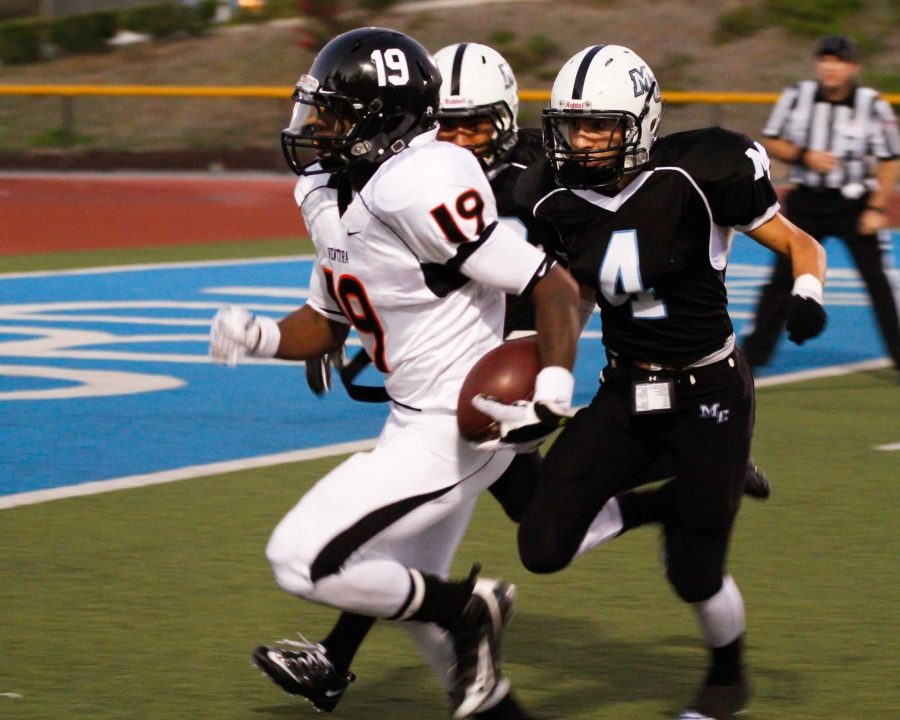 The Raider's Victor Fermin, 4, closes on the Pirates Franky Dunn, 19, during the Citrus Cup at Griffin Stadium on September 3, 2011. The Pirates held onto the cup with a 31-26 win