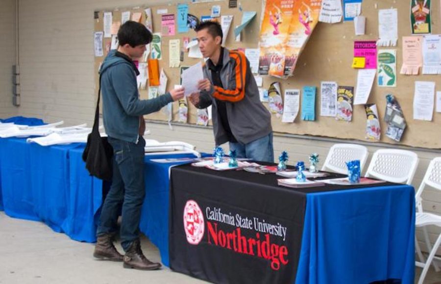 Moorpark College sophomore Johan Karlsson consults with Cal State University Northridge International Students Admissions representative Tom Yee at Moorpark College on November 10, 2011.