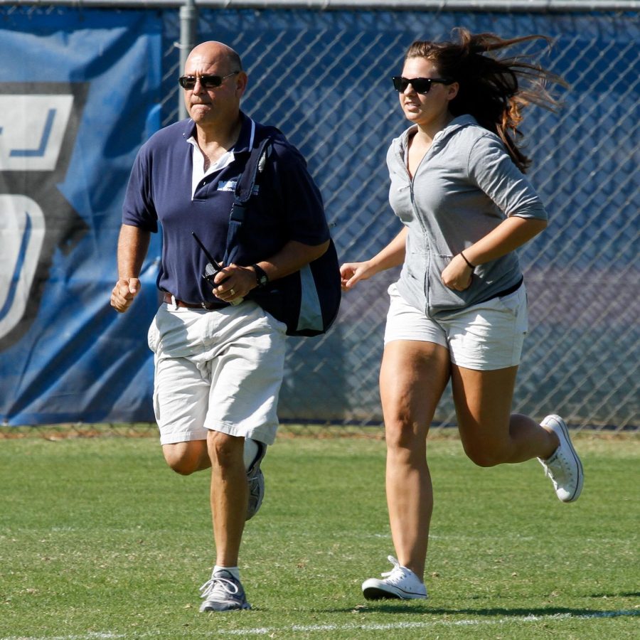 Moorpark College Athletic Trainer Vance Manakas and student Christina Gallo run to the aid of an injured player during a soccer match at Raider Field on September 23, 2011.