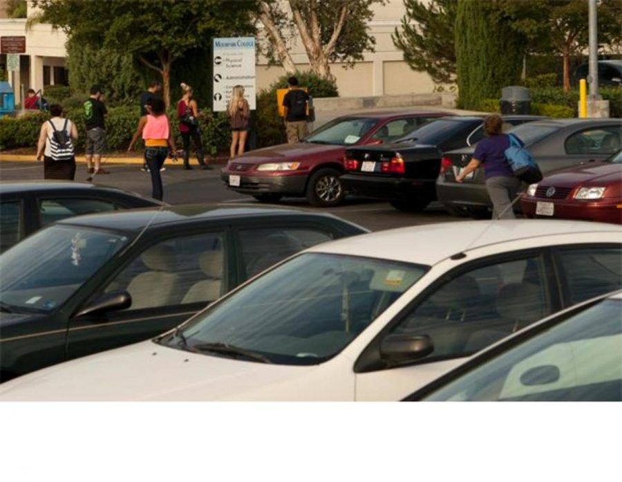 Students wait in line to buy a parking permit in the parking lot of Moorpark College, on 8/21/12  -Photo By Sam Mora