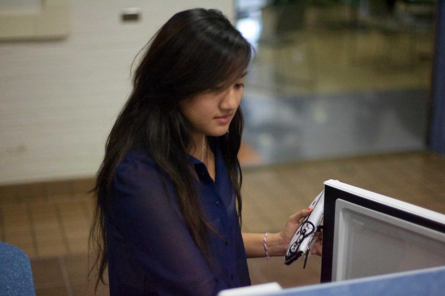 Evelyn Huynh goes to retrive her 'Cup-o-Noodle' from one of many new machines that have been put in place this semester.