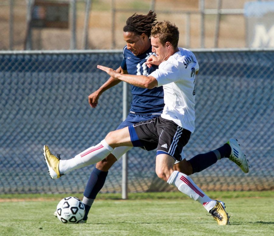 Moorpark College Raider Antoinne Felton, blue, competes against a Santa Ana College Don defender at Moorpark College on Tues.,August 28, 2012. The match ended in a draw, 0-0. -Photo By Jeff Farrar