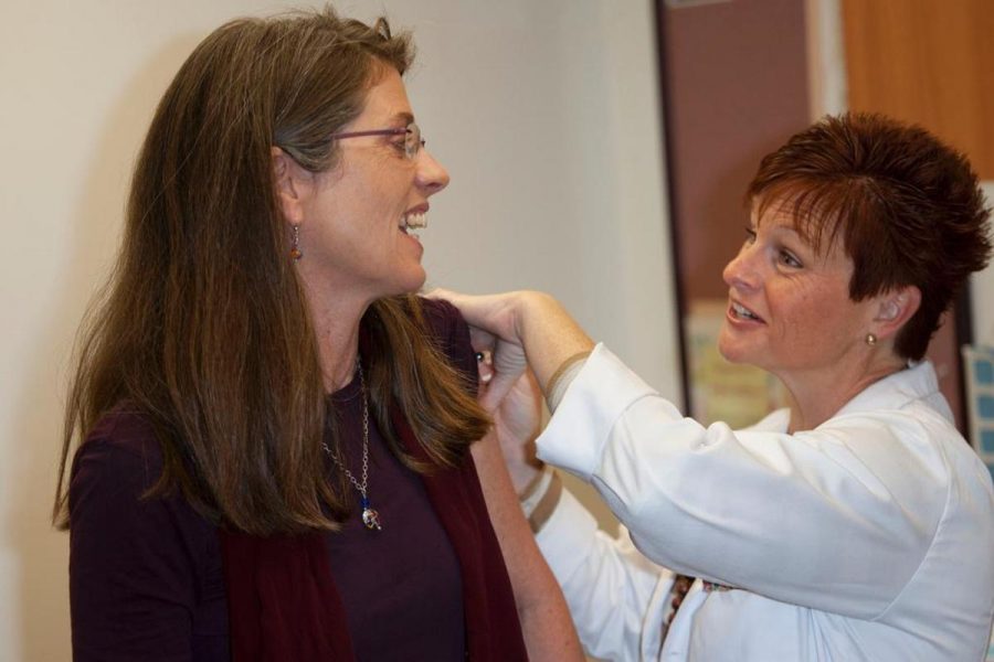 Dr. Laura Forsyth receives a flu shot from Dena Stevens, Registered Nurse in the health office at Moorpark College. Photo By Sam Mora