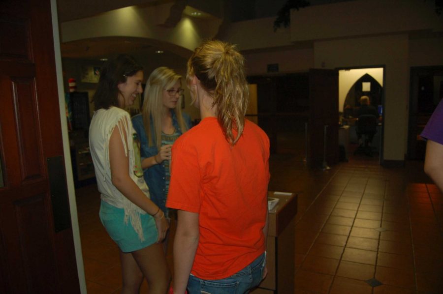 Lauren Aboytes, left, and Rachel Blaznek, right, laugh it up with an Improv-A-Sutra player before the show. -Photo by Samantha Lieb