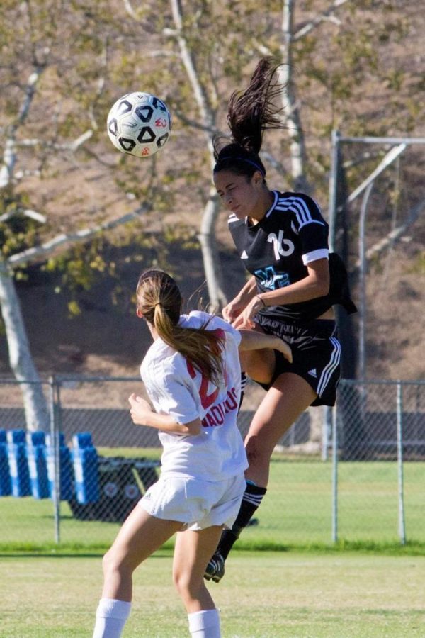 #16 Jennifer Brown heads the ball in the Raiders loss Nov. 6