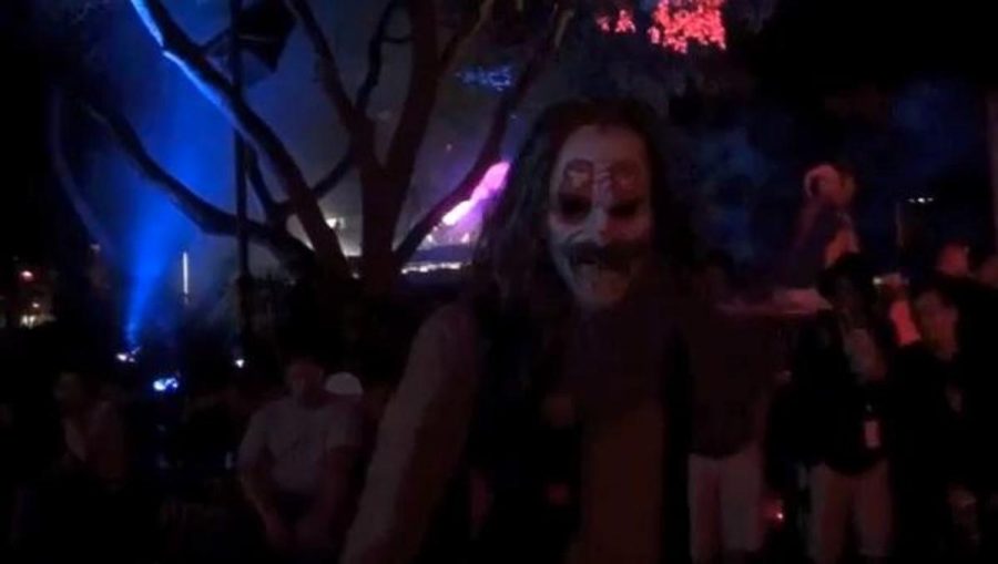 A halloween scarer pops out to startle thrill seekers at Horror Nights. 