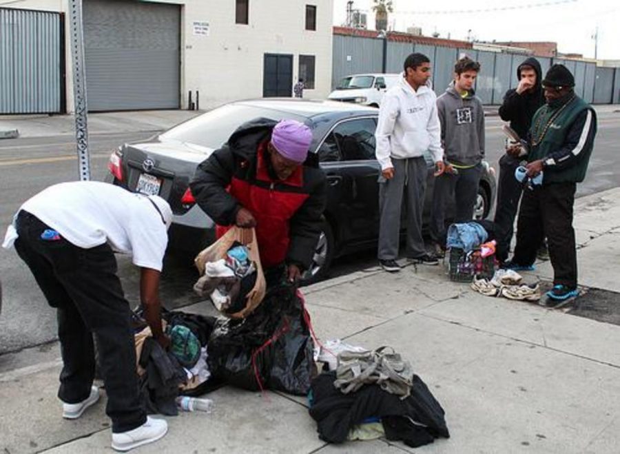 Kristopher Dowling, 20, Joe Standell, 20, and Scotty Langdon, 19, pass out donated clothes to the homeless of Skid Row in Los Angeles.