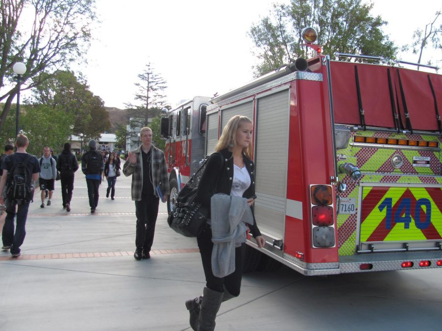 A firetruck sits in the middle of Raider Walk while emergency workers help inside of fountain hall during an on-campus emergency.