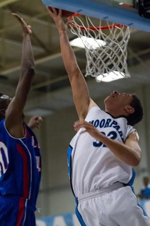 Zach Davis, power forward for the Raiders, dunks the ball. 