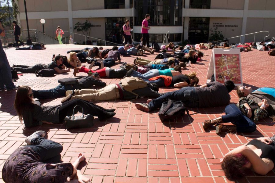 Students at Moorpark College drop to the ground to raise awareness about violence against women. 