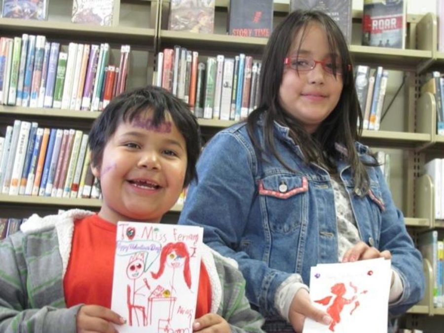 Six- year old Adrian  Estrada and  Adriana Lopez ,11, show off there Valentines Day card they made as part of a Monthly Craft Program. 