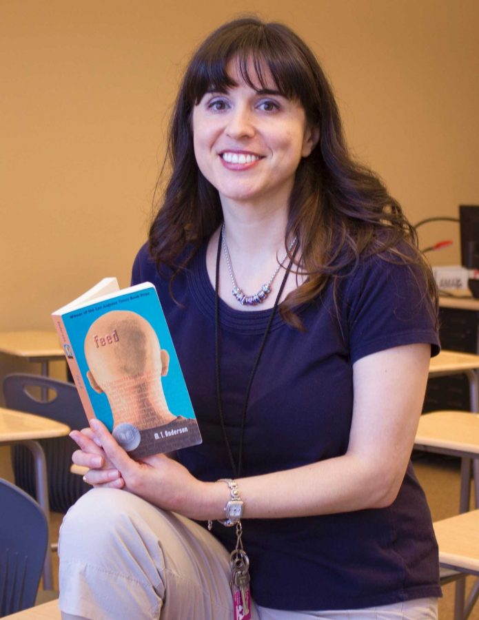 English professor Diane Scrofano strikes a pose with “Feed”, the winner of next year’s One Campus, One Book! selection.