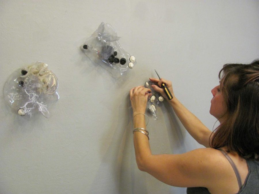 Lana Shuttleworth setting up her art work in the Moorpark College Art Gallery.
