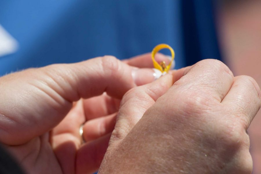 Dena Stevens, Moorpark College Nurse, is tying yellow ribbons to give to students during Suicide Prevention Week.