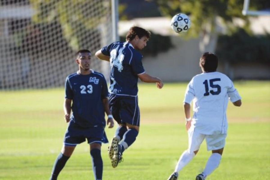Michael Trejo, far left, assists his teamate, Mike Phillips, on a defensive stop against Santa Barbara. The Raiders lost 3-1.