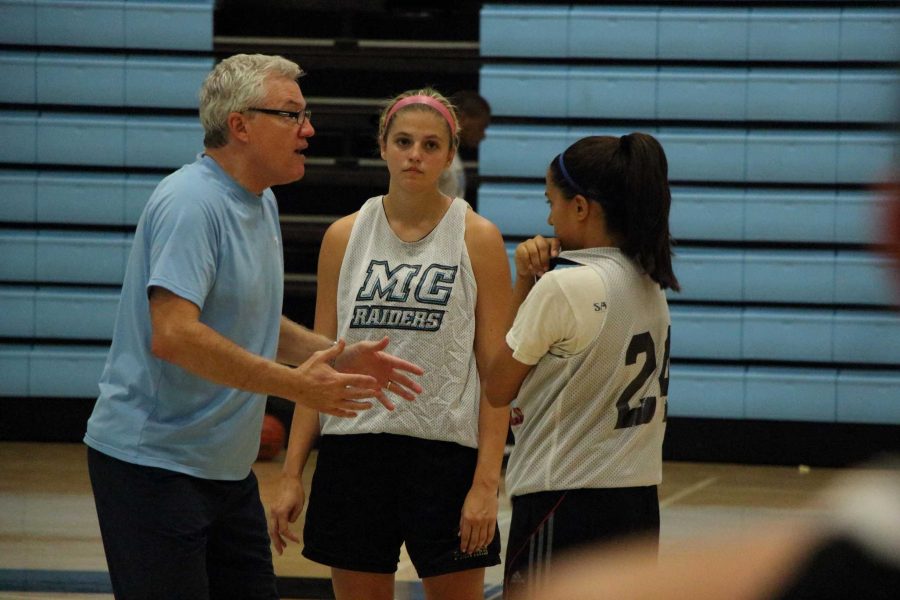 Remy McCarthy (Right) directs his players, Alison Dobner (Center) and Jackie Valenzuela (left), during a pre-season practice.