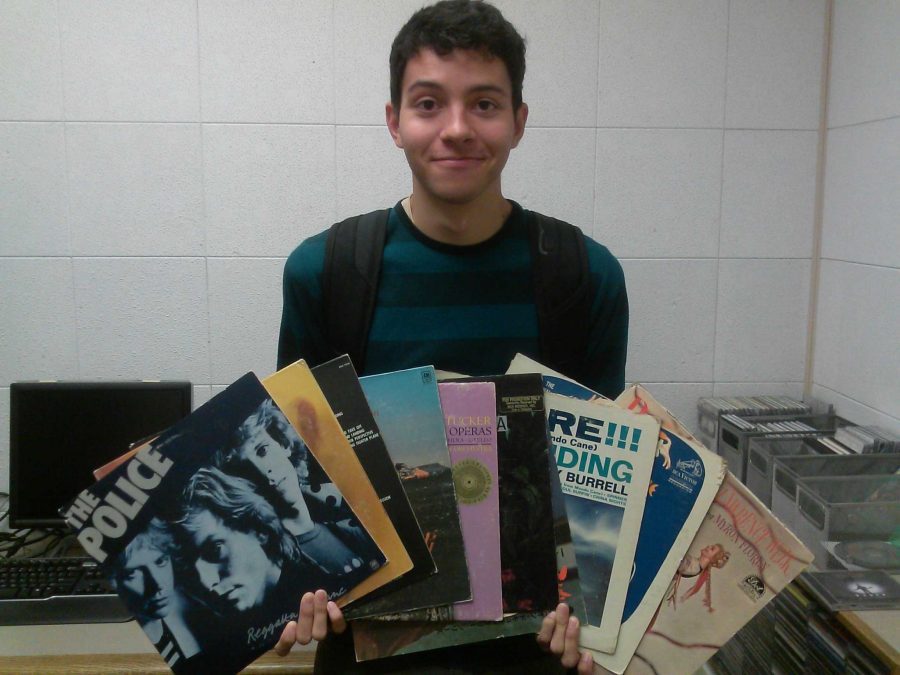 Kennedy, 19, posing with some familiar records he found in Moorpark's Radio Control room. Photo by Caleb Sperling